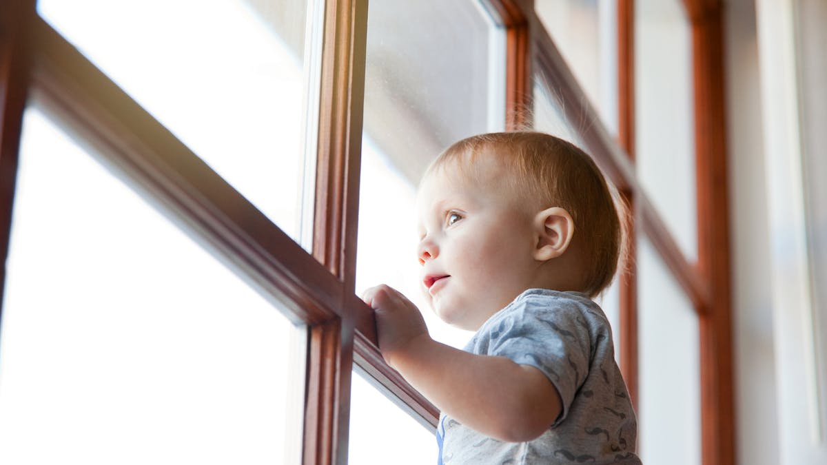 Enfant regardant par la fenêtre