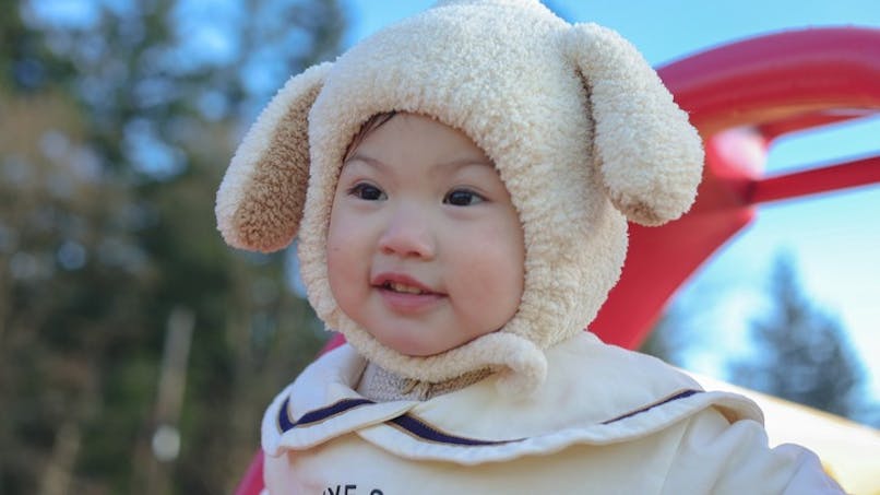 bébé avec un bonnet mouton