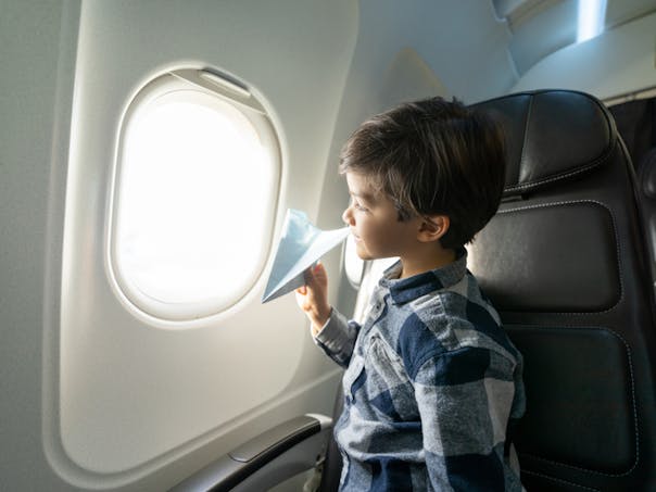 garçon regardant dans hublot d'un avion