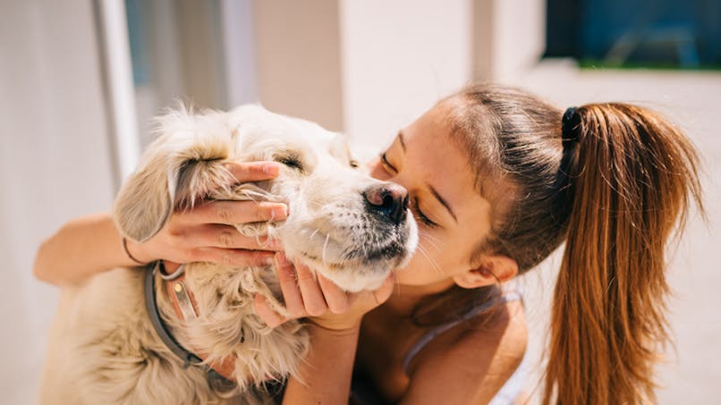 petite fille embrassant son chien