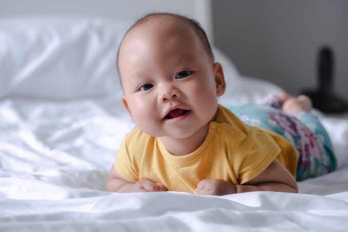 joli bébé asiatique  sur le lit